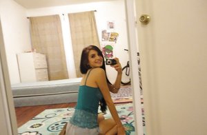 18 year old girl Megan Rain removes her sandals and then clothes to pose naked